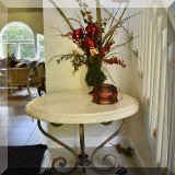 F51. Kreiss Collection round table with polished stone top.